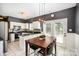Eat-in kitchen with white cabinets, stainless steel appliances, and granite countertops at 9808 Steed Ct, Charlotte, NC 28269