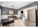 Bright kitchen with stainless steel refrigerator, granite countertops, and an adjacent dining area with stylish lighting at 9808 Steed Ct, Charlotte, NC 28269