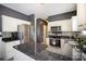 Bright kitchen with stainless steel appliances, granite countertops, white cabinets, and a decorative backsplash at 9808 Steed Ct, Charlotte, NC 28269
