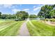 Stroll along the path to the gazebo by the lake, perfect for relaxing or enjoying scenic community views at 9808 Steed Ct, Charlotte, NC 28269