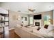 Cozy living room with a fireplace, hardwood floors, and neutral-colored sectional at 9808 Steed Ct, Charlotte, NC 28269
