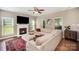 Bright living room featuring a fireplace, hardwood floors, and large sectional sofa at 9808 Steed Ct, Charlotte, NC 28269