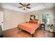 Comfortable main bedroom with a trey ceiling, modern decor, hardwood floors, and ample natural light at 9808 Steed Ct, Charlotte, NC 28269