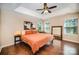 Inviting primary bedroom featuring a trey ceiling, hardwood floors, large mirror, and natural light from the windows at 9808 Steed Ct, Charlotte, NC 28269