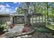 Spacious backyard with an outdoor grill, stone chimney, and a covered porch area for relaxation at 1003 Cranberry Cir, Fort Mill, SC 29715