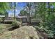 Expansive backyard with mature trees, stone chimney, and a deck area offering scenic views at 1003 Cranberry Cir, Fort Mill, SC 29715