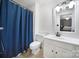 Bright bathroom with a vanity, mirror, and a shower with a blue curtain at 1003 Cranberry Cir, Fort Mill, SC 29715
