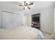 Bright bedroom featuring a ceiling fan, closet, and bookcase with a television for your enjoyment at 1003 Cranberry Cir, Fort Mill, SC 29715