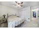 Cozy bedroom with a floral-patterned comforter, ceiling fan, and closet for ample storage space at 1003 Cranberry Cir, Fort Mill, SC 29715