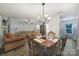Cozy dining area with modern laminate flooring, chandelier lighting, and an open layout connecting to the living spaces at 1003 Cranberry Cir, Fort Mill, SC 29715