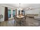 Bright dining area featuring laminate flooring, modern chandelier, and French doors that lead to the outdoor living space at 1003 Cranberry Cir, Fort Mill, SC 29715