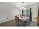 Elegant dining room featuring laminate flooring, modern chandelier, and French doors providing natural light and backyard access at 1003 Cranberry Cir, Fort Mill, SC 29715