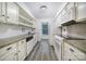 Galley kitchen featuring white cabinetry, sleek countertops, and modern appliances at 1003 Cranberry Cir, Fort Mill, SC 29715