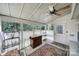 Cozy sunroom with large windows, tile flooring, and a ceiling fan for year-round enjoyment at 1003 Cranberry Cir, Fort Mill, SC 29715