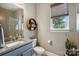 Bathroom featuring modern sink with granite countertop and round wooden shelf at 1009 Hercules Dr, Indian Trail, NC 28079
