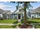 Charming home featuring well-manicured lawn, flower beds, and a lovely walkway to the front door at 1009 Hercules Dr, Indian Trail, NC 28079
