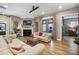 Open-concept living area with fireplace, hardwood floors, comfortable seating, and access to the outdoors at 1009 Hercules Dr, Indian Trail, NC 28079