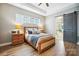 Inviting main bedroom features wood floors, plenty of light, a decorative barn door leading to the ensuite bath at 1009 Hercules Dr, Indian Trail, NC 28079