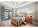 Main bedroom featuring a tray ceiling, natural light and hardwood floors at 1009 Hercules Dr, Indian Trail, NC 28079