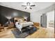 Bedroom boasts wood floors, ceiling fan, accent wall, and modern furnishings at 1009 Hercules Dr, Indian Trail, NC 28079