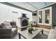 Relaxing covered outdoor patio with stone fireplace, comfortable seating, and TV at 1009 Hercules Dr, Indian Trail, NC 28079