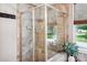 Shower featuring a glass door, tiled walls, and natural light at 1009 Hercules Dr, Indian Trail, NC 28079