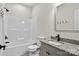 Bright bathroom featuring a shower-tub combination, granite-topped vanity, and black hardware at 1019 Null Rd, Lincolnton, NC 28092