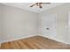 Simple bedroom with hardwood floors, ceiling fan, and closet with white double doors at 1019 Null Rd, Lincolnton, NC 28092