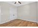 Simple bedroom with hardwood floors, ceiling fan, and closet with white double doors at 1019 Null Rd, Lincolnton, NC 28092