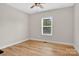 Neutral bedroom with hardwood floors, ceiling fan, and window providing natural light at 1019 Null Rd, Lincolnton, NC 28092