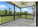 Deck with a ceiling fan and black railings showcasing a serene backyard at 1019 Null Rd, Lincolnton, NC 28092