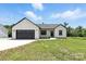 Well-maintained home with an attached garage, surrounded by lush green grass at 1019 Null Rd, Lincolnton, NC 28092