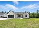 Charming modern farmhouse with a well-manicured lawn, garage, and front garden at 1019 Null Rd, Lincolnton, NC 28092
