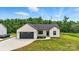 Beautiful modern farmhouse with a well-kept lawn and a dark-colored garage door at 1019 Null Rd, Lincolnton, NC 28092