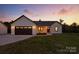 Charming home showcasing a well-manicured lawn and a modern farmhouse design at dusk at 1019 Null Rd, Lincolnton, NC 28092