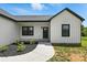 Close-up of a charming modern farmhouse with tidy landscaping and a stone walkway at 1019 Null Rd, Lincolnton, NC 28092