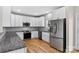 Well-equipped kitchen features stainless steel appliances, white cabinets, and hardwood floors at 1019 Null Rd, Lincolnton, NC 28092
