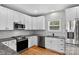 Updated kitchen features granite countertops, white cabinets, and stainless steel appliances at 1019 Null Rd, Lincolnton, NC 28092