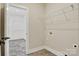Bright laundry room with wire shelves and neutral paint at 1019 Null Rd, Lincolnton, NC 28092