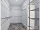 Walk-in closet with custom shelving and tiled flooring at 1019 Null Rd, Lincolnton, NC 28092