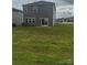 Exterior shot of backyard and house with vinyl siding and manicured lawn at 1022 Jeffery Dean Ct, Albemarle, NC 28001