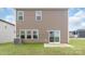 Exterior of the home showing siding, windows, a concrete patio, and a small grassy yard at 1022 Jeffery Dean Ct, Albemarle, NC 28001