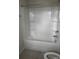 Bright bathroom featuring a white shower-tub combo with built-in shelving for added convenience at 1022 Jeffery Dean Ct, Albemarle, NC 28001