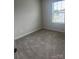 Well-lit bedroom featuring neutral walls, carpet, and a window offering a peaceful view at 1022 Jeffery Dean Ct, Albemarle, NC 28001