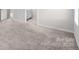 Spacious bedroom with neutral carpet, base trim, and a view into a nearby bathroom at 1022 Jeffery Dean Ct, Albemarle, NC 28001