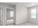 Bedroom with plush carpet, windows with blinds, and a view into another room at 1022 Jeffery Dean Ct, Albemarle, NC 28001