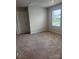 A cozy bedroom features plush carpeting and a window bringing in natural light at 1022 Jeffery Dean Ct, Albemarle, NC 28001
