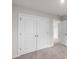 Bedroom with plush carpet, closet with double doors, and doors to additional rooms at 1022 Jeffery Dean Ct, Albemarle, NC 28001