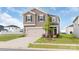 Two-story home featuring a two-car garage, tan siding, a manicured lawn and well-maintained landscaping at 1022 Jeffery Dean Ct, Albemarle, NC 28001