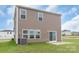 Exterior of the home showing siding, windows, a concrete patio, and a small grassy yard at 1022 Jeffery Dean Ct, Albemarle, NC 28001
